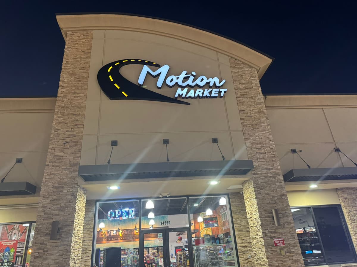 Illuminated Motion Market channel letter sign at night