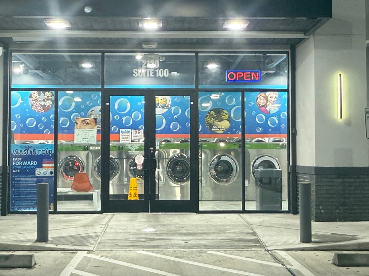 Colorful storefront window graphics for a laundromat